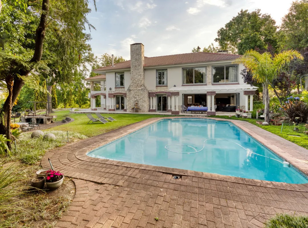 A spacious brick patio at Bonne Chance Luxury estate, featuring a pool and relaxation area in Stellenbosch.