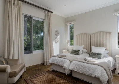 Bedroom in Le Palmier self-catering cottage at Bonne Chance Luxury estate, featuring elegant decor and serene ambiance.