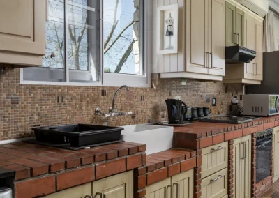 Modern kitchen in Le Palmier cottage, featuring sleek appliances and elegant decor at Bonne Chance Luxury estate, Stellenbosch.