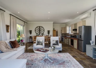 Stylish living room of Le Palmier self-catering cottage at Bonne Chance Luxury estate, showcasing comfortable seating and decor.