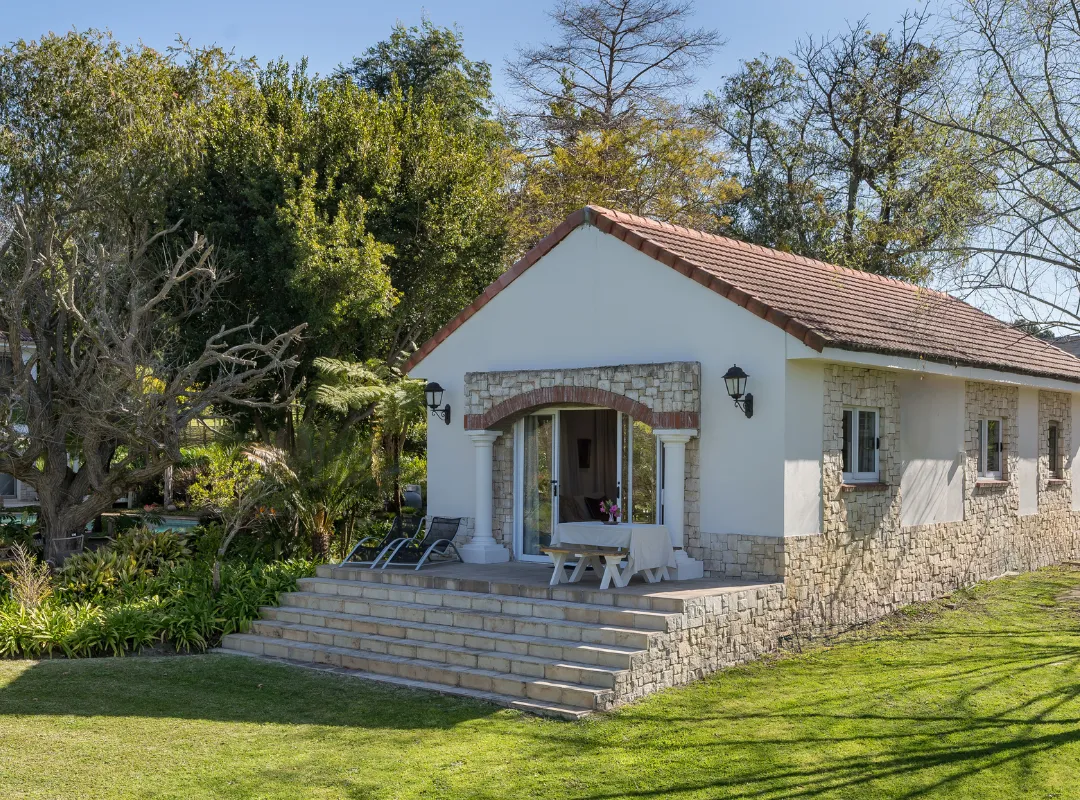 Le Palmier self-catering cottage at Bonne Chance Luxury estate, surrounded by lush greenery in Stellenbosch.